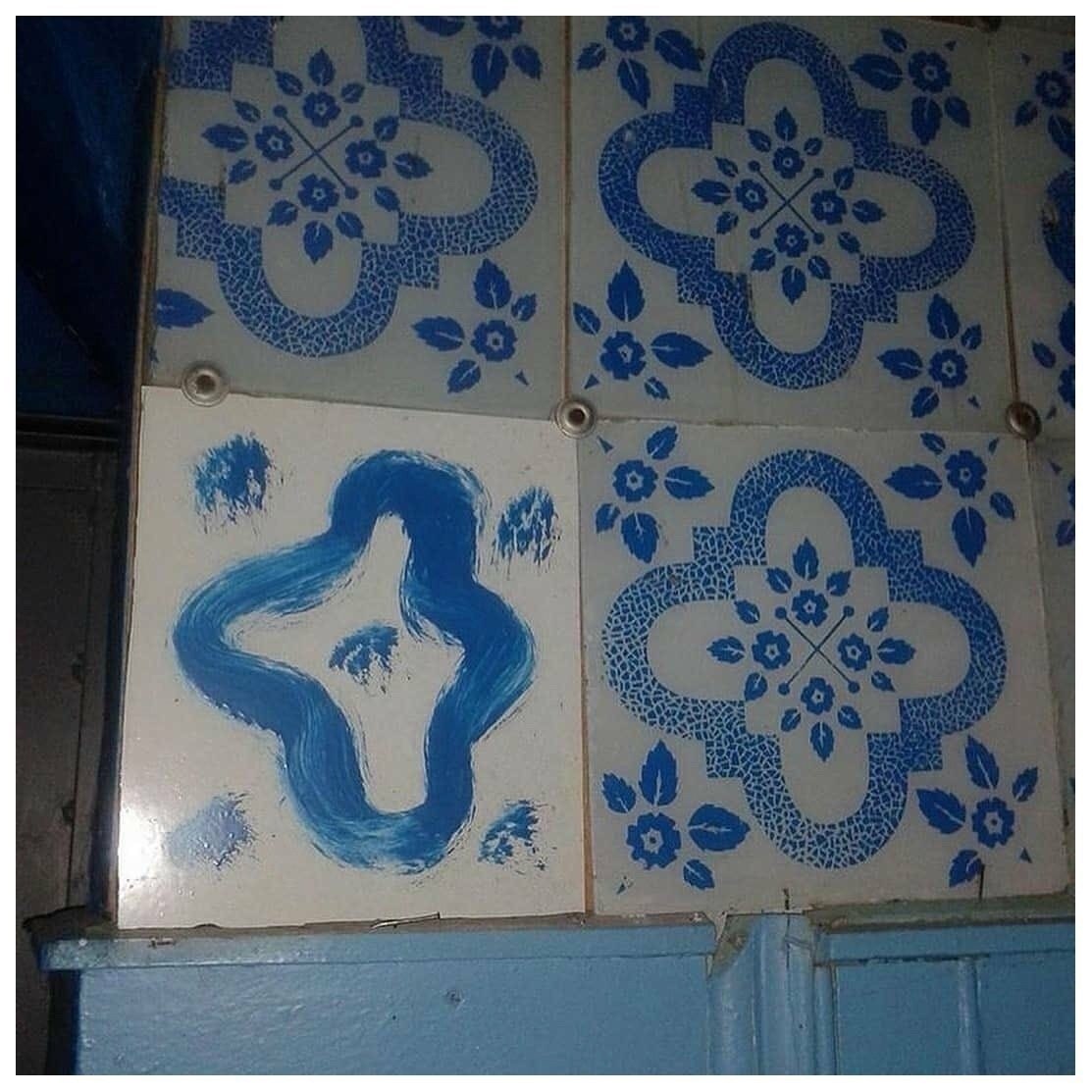 a blue and white tile with a woman on it